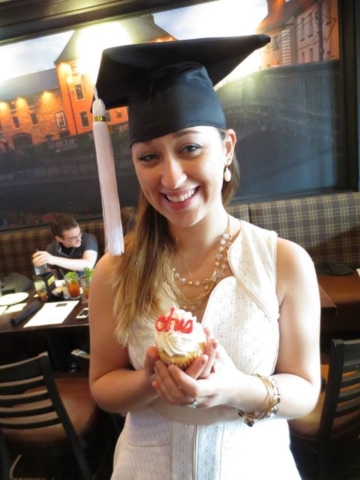 Ohio state graduate holding Fate Cakes cupcake