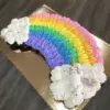 Rainbow themed cupcake cake with unicorn decoration