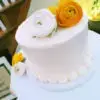 Smooth icing wedding cake with flowers