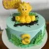 Dino themed cake with fondant decorations and topper