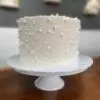6" White smooth icing with white pearl sprinkles