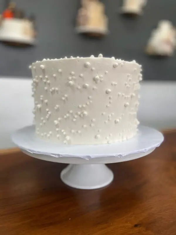 6" White smooth icing with white pearl sprinkles