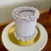 4" Smooth circle with light purple icing and white pearl sprinkles