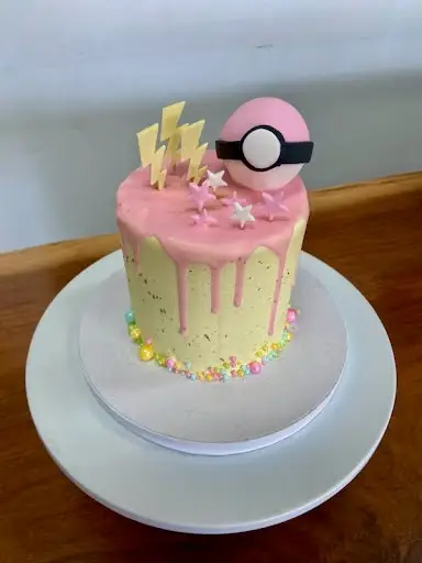 4" Pokemon theme with chocolate drip, edible gold splatter, sprinkles and fondant toppers