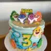 8" Icing texture Baby Shark theme with fondant details and edible images on side, and paper toppers