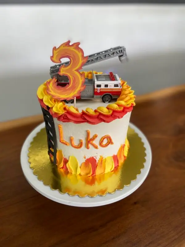 6" Firetruck theme with fondant and icing details, paper number topper and plastic vehicle topper