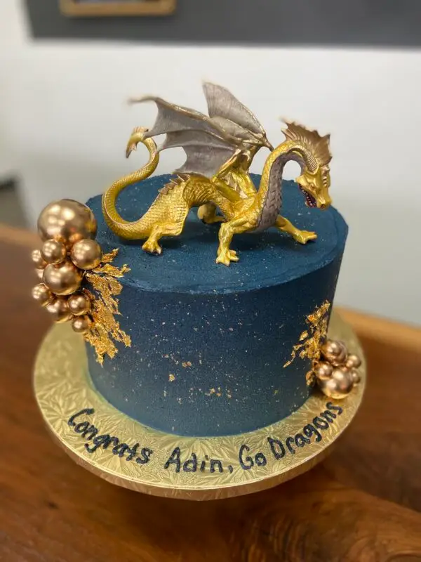 8" Dragon theme with edible gold splatter/leaf, and plastic topper/balls