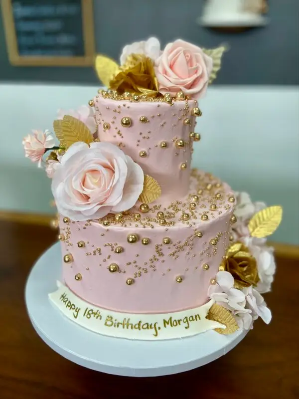 4"/8" with pearl sprinkles, artificial flowers and fondant message banner