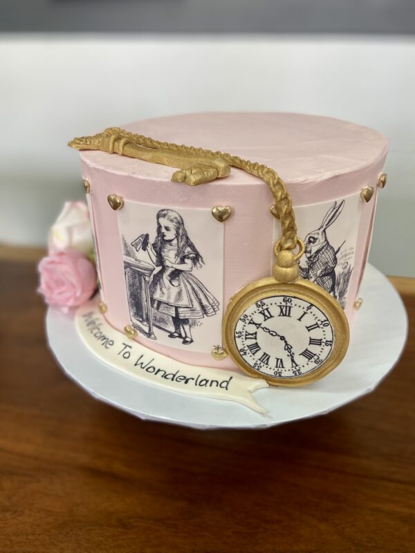 8" Alice in wonderland them with edible images, fondant decorations and artificial flowers and fondant banner