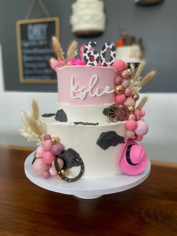 6"/10" Cowgirl theme with plastic toppers, artificial flowers and acrylic name plaque