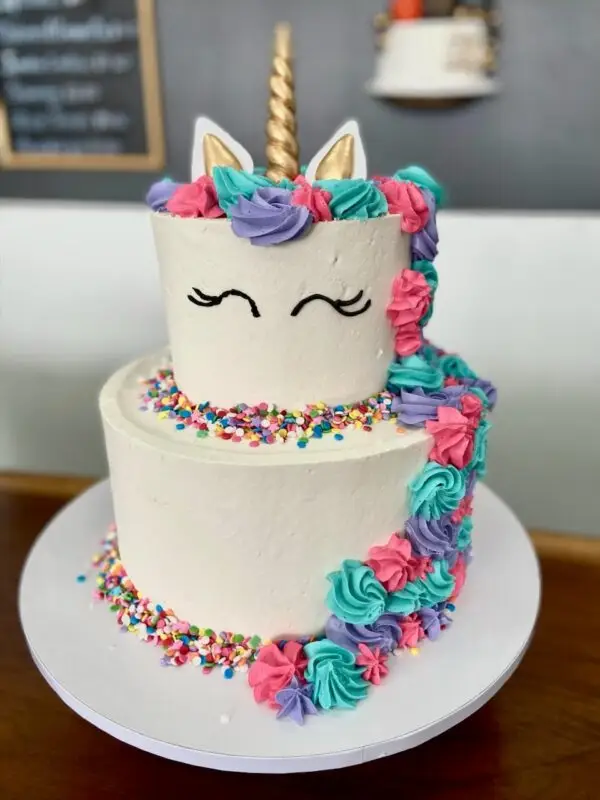 6"/10" unicorn theme with icing main, sprinkles and plastic horn/ears